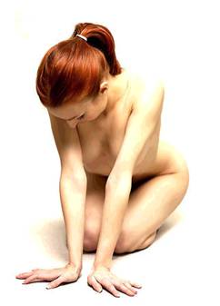 Heather kneeling naked on the floor