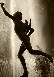 Falguière's Cockfight - weathered copy in a park, backlit against fountain, sepia, by Pierre Beteille on Flickr