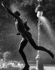 Falguière's Cockfight - weathered copy in a park, backlit against fountain, by Pierre Beteille on Flickr