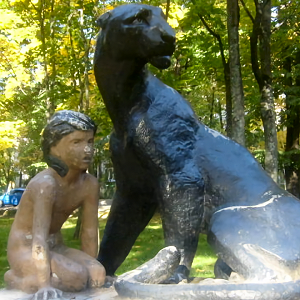 Statue of Mowgli, Priozersk, Russia - Front right, mottled sunlight